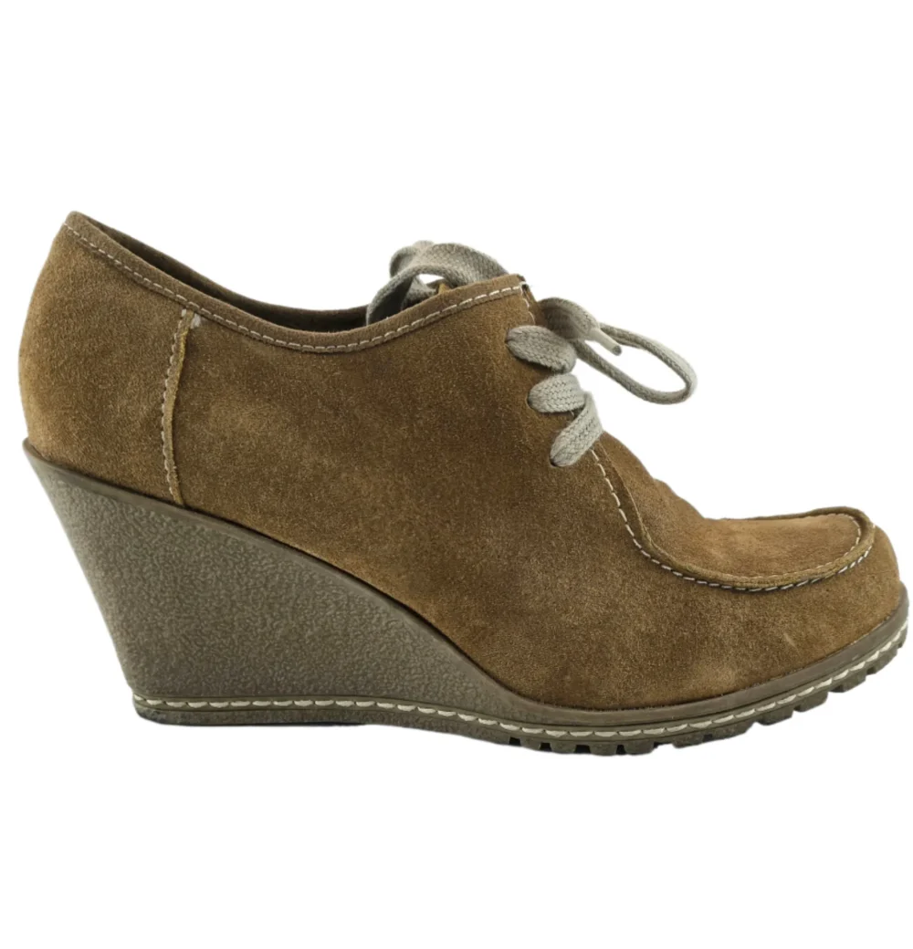Side view of vintage suede wedge shoes with lace-up closure and stitched details