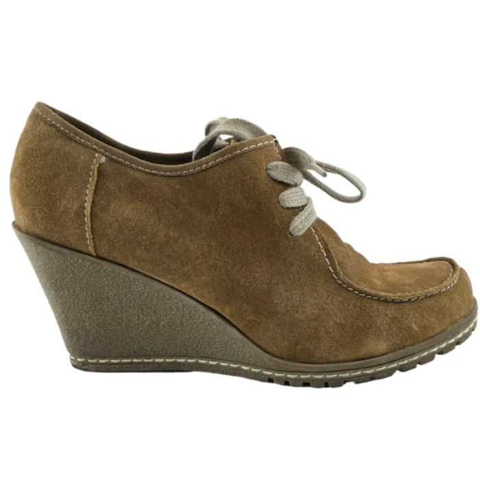 Side view of vintage suede wedge shoes with lace-up closure and stitched details