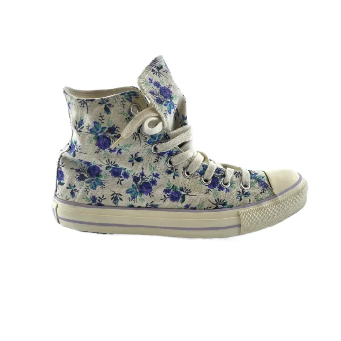Vintage Converse floral high-top sneaker with a cream canvas and blue floral print. Vintage Converse floral high-top sneaker with a cream canvas and blue floral print.