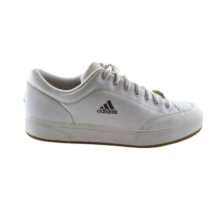 A white leather Adidas sneaker with a black logo on the side, shown in profile. The shoe has slight signs of wear, and the sole features a rubber edge. A white leather Adidas sneaker with a black logo on the side, shown in profile. The shoe has slight signs of wear, and the sole features a rubber edge.