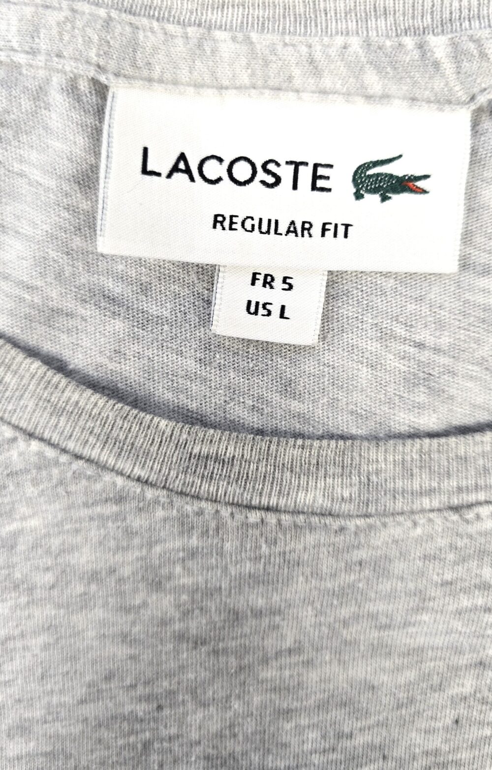 Close-up of the Lacoste label showing size and fit on the vintage grey T-shirt